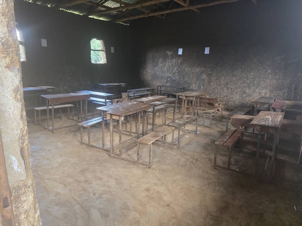 Empty classroom with wooden desks and benches
